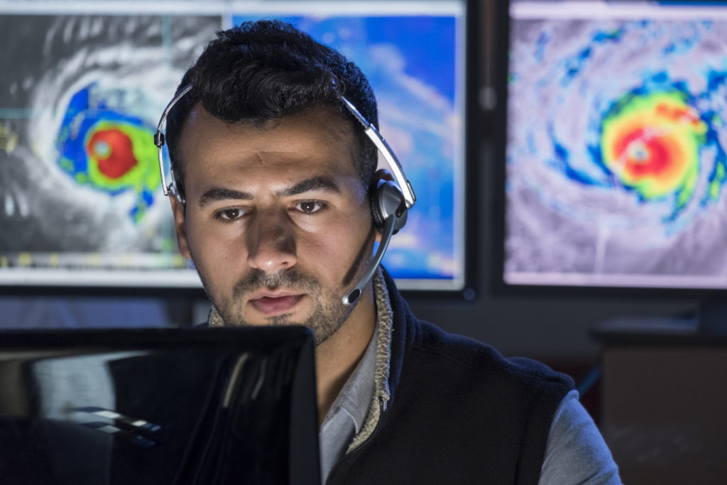 man in emergency operations center wearing a headset