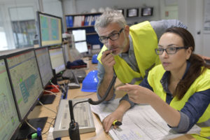 emergency response SOP in action; two security officers looking at monitors