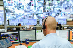 man in control center and emergency operations center monitoring emergency communications