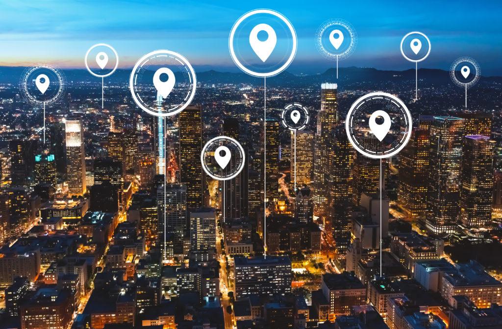 location markers popping up over an evening city skyline