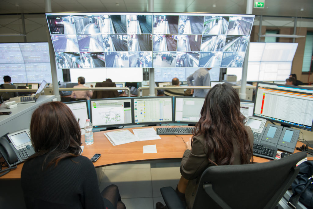 two employees in a security and emergency operations center