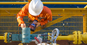 oil worker working on a rig while wearing safety and protective gear