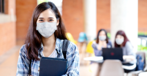 student wearing a mask on a college campus