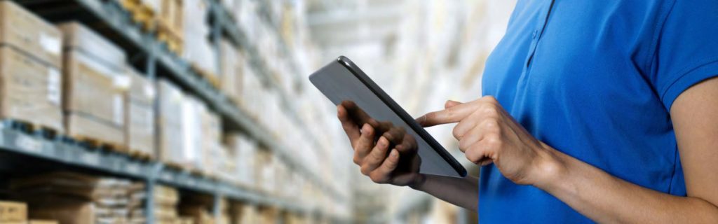 warehouse worker taking inventory on tablet