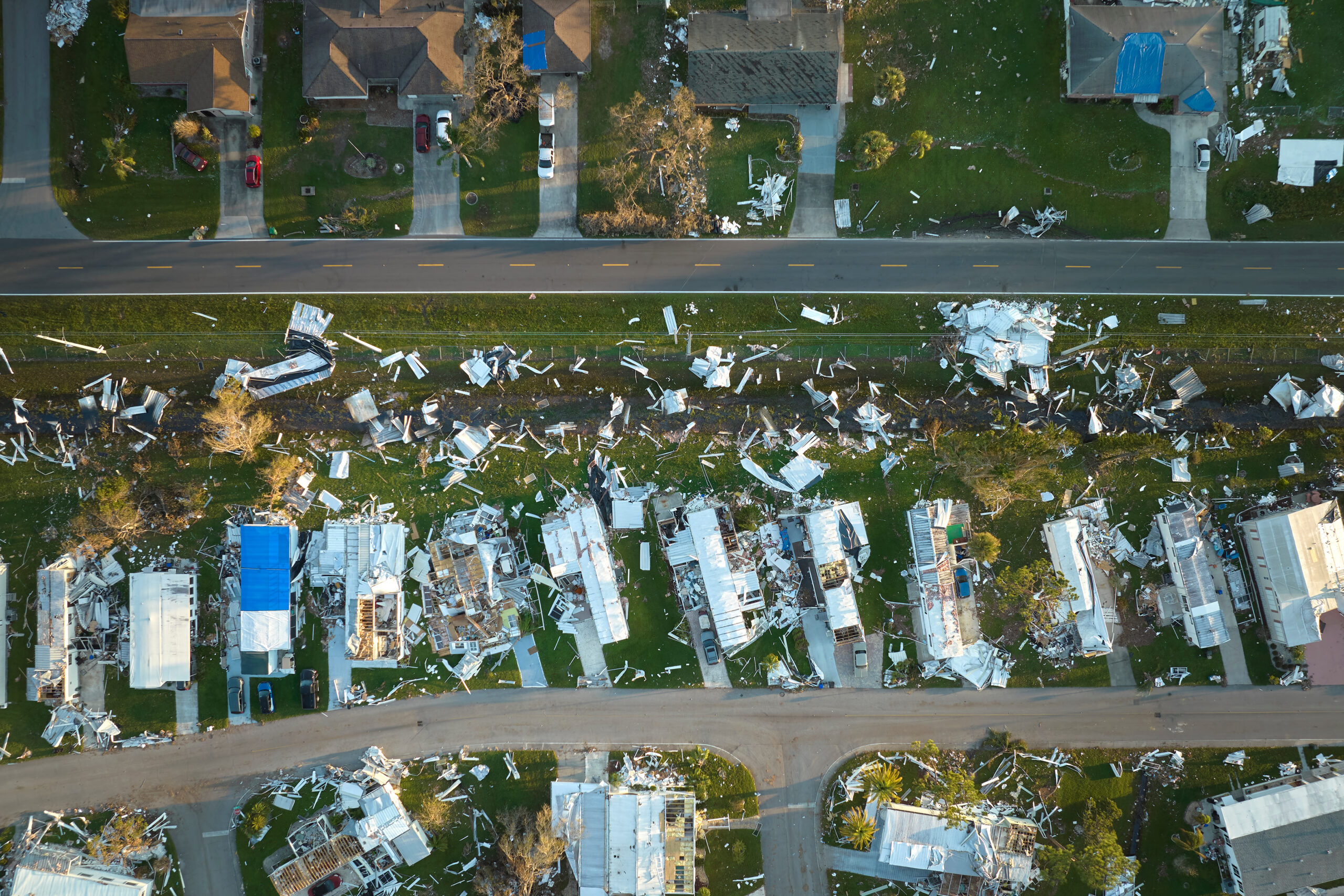 Hurricane Ian destroyed homes in Florida residential area. Natural disaster and its consequences.