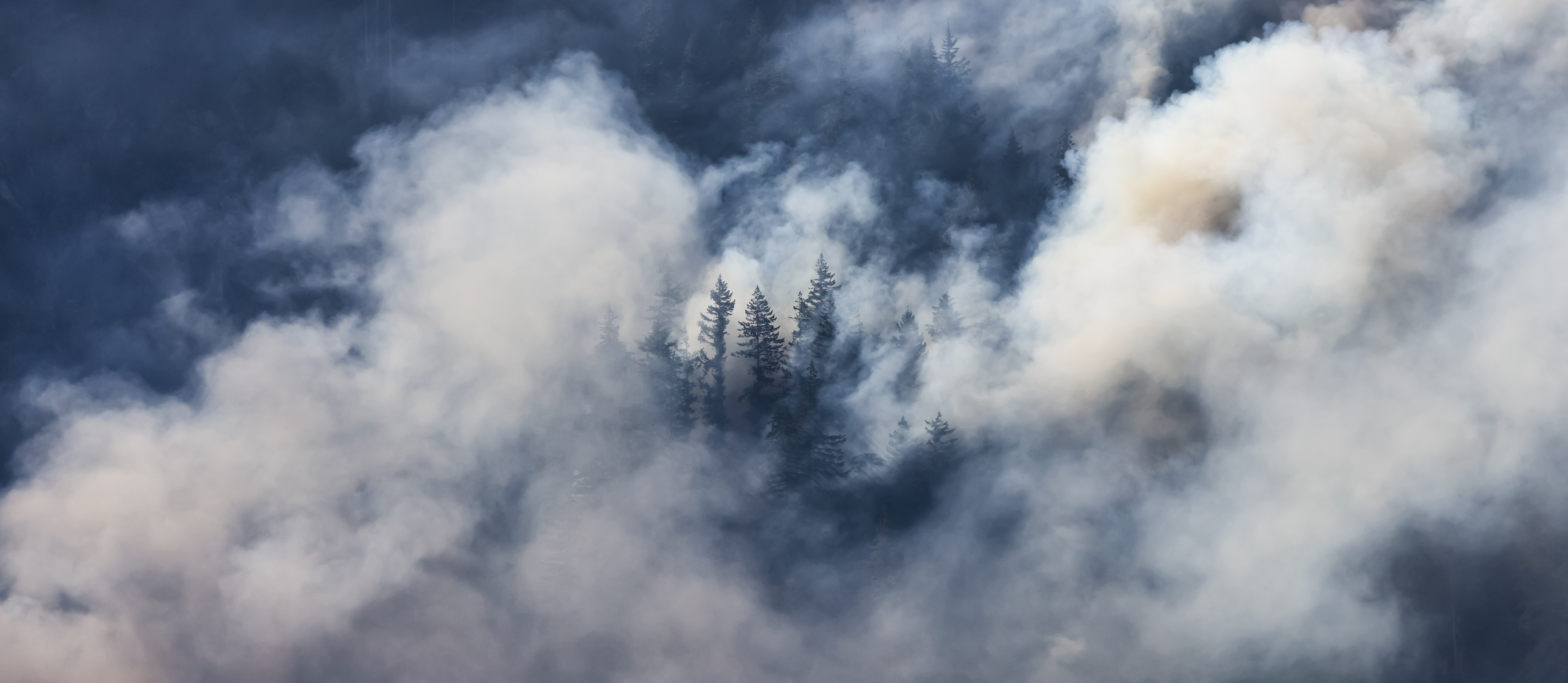 BC Forest Fire and Smoke over the mountain near Hope during a hot sunny summer day.